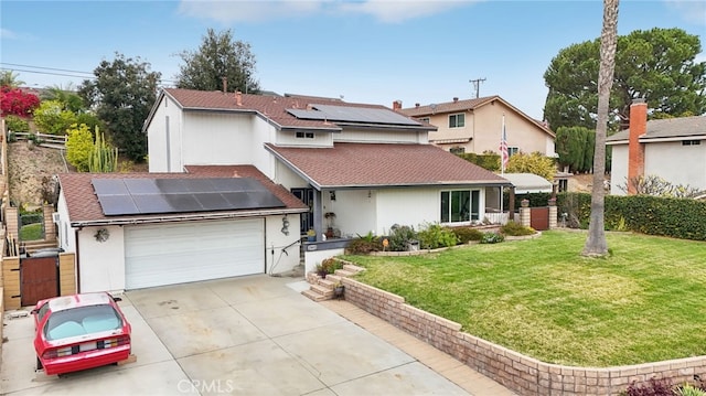 view of front of home with a garage, solar panels, driveway, roof with shingles, and a front yard