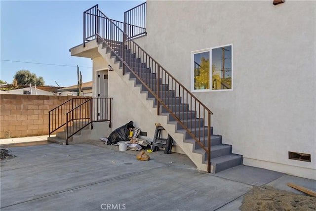 interior space with stairway and fence