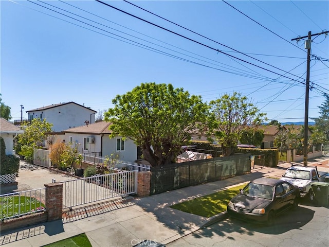 view of front of home featuring a fenced front yard and stucco siding