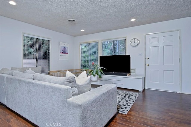 living room featuring recessed lighting, visible vents, and dark wood-style floors