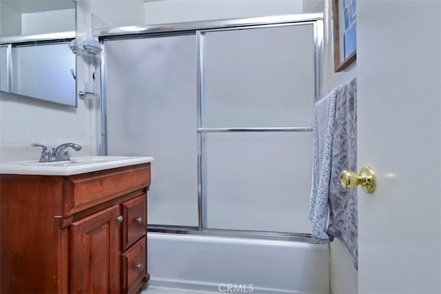 full bathroom featuring enclosed tub / shower combo and vanity