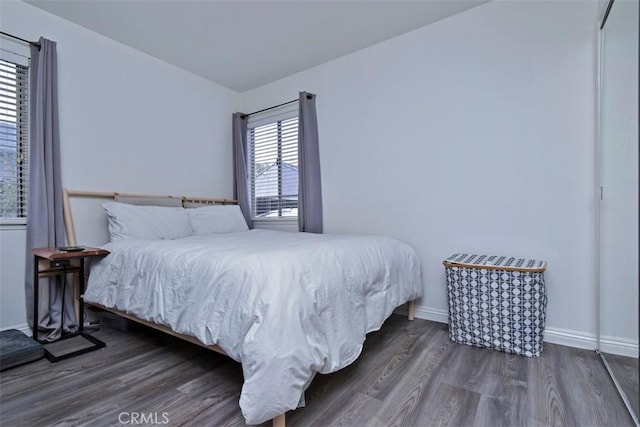 bedroom featuring baseboards and wood finished floors