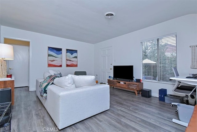 living room featuring visible vents and wood finished floors