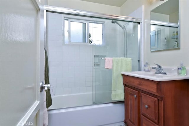 full bathroom featuring vanity and shower / bath combination with glass door