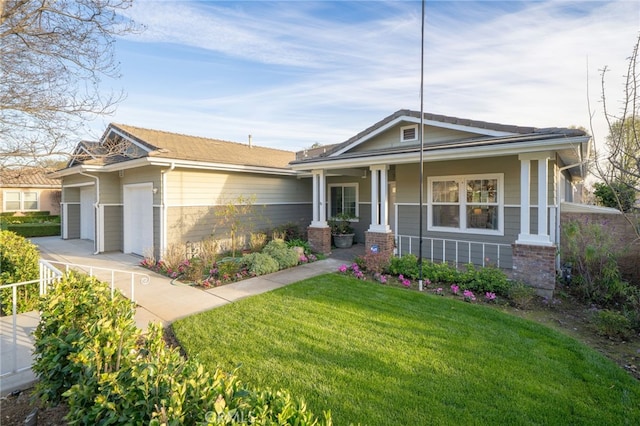 view of front of home featuring a garage, covered porch, brick siding, and a front yard