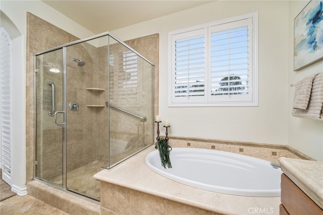 full bathroom featuring a garden tub, a shower stall, and vanity