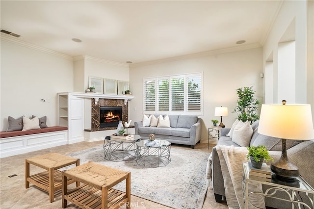 living room featuring a fireplace, visible vents, and crown molding