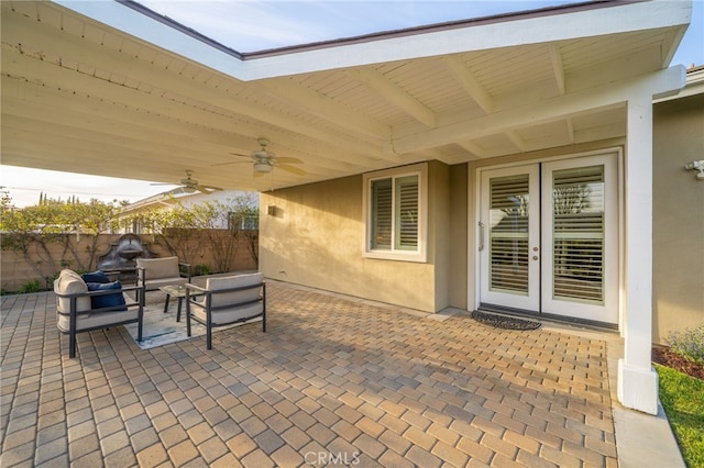 view of patio / terrace with fence, an outdoor hangout area, a ceiling fan, and french doors