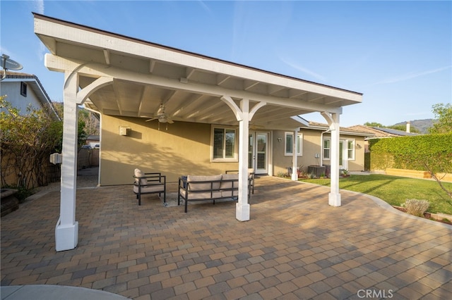 view of patio / terrace featuring an outdoor living space, fence, and a ceiling fan