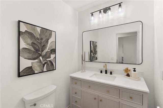 bathroom featuring toilet and vanity