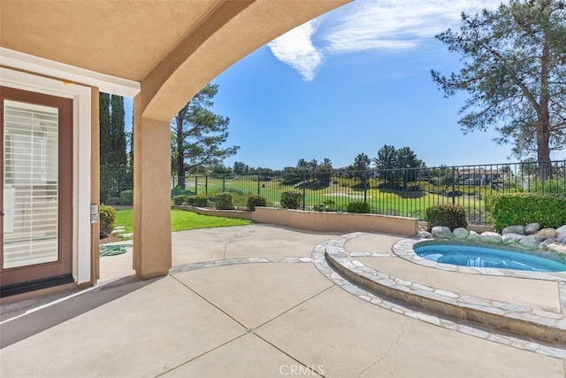 view of swimming pool with an in ground hot tub, a patio, and fence