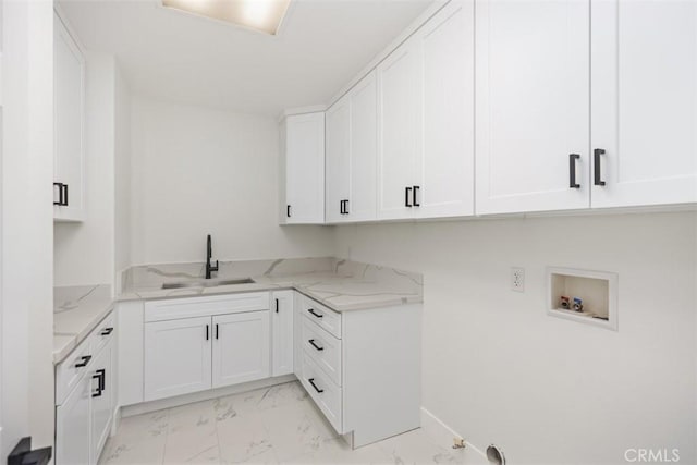 laundry room featuring marble finish floor, cabinet space, a sink, and hookup for a washing machine