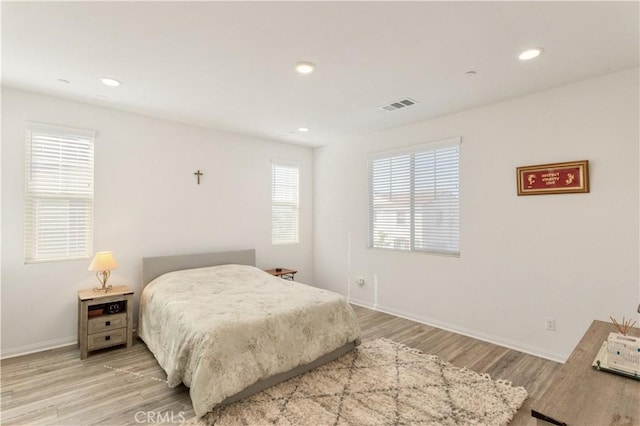 bedroom featuring recessed lighting, baseboards, visible vents, and light wood-style flooring