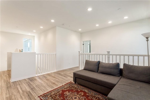 living area with recessed lighting and light wood-style flooring