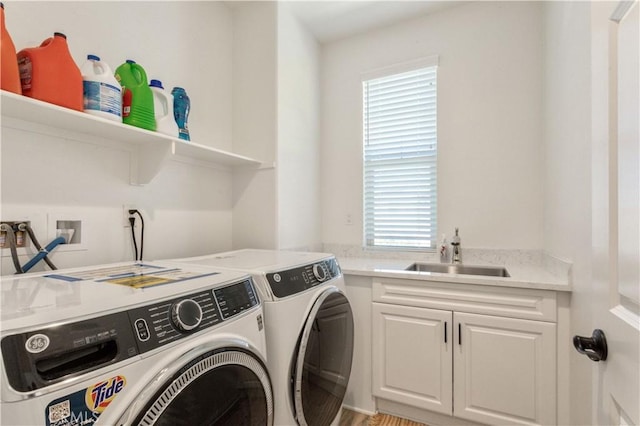 laundry area with a sink, cabinet space, washer and dryer, and a healthy amount of sunlight