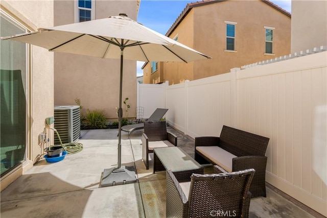 view of patio / terrace featuring an outdoor living space, a fenced backyard, and central AC