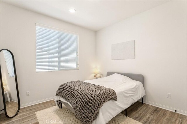 bedroom featuring recessed lighting, baseboards, and wood finished floors