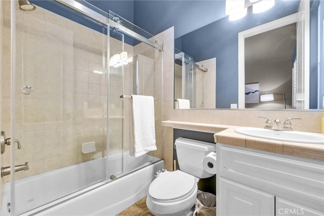 full bathroom featuring toilet, combined bath / shower with glass door, backsplash, and vanity