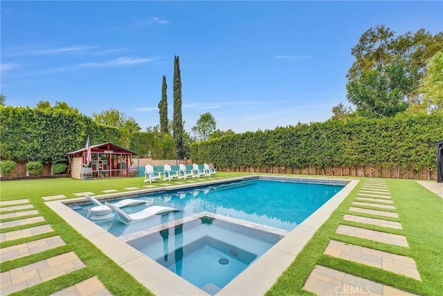 view of pool featuring a fenced backyard, a pool with connected hot tub, a playground, and a yard