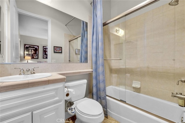 full bathroom featuring enclosed tub / shower combo, vanity, and toilet