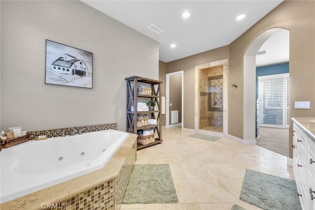 bathroom featuring a stall shower, visible vents, a tub with jets, tile patterned flooring, and vanity