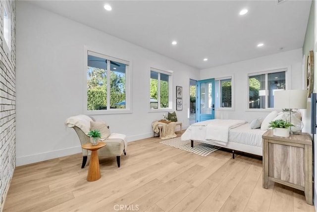 bedroom featuring baseboards, light wood-style flooring, and recessed lighting