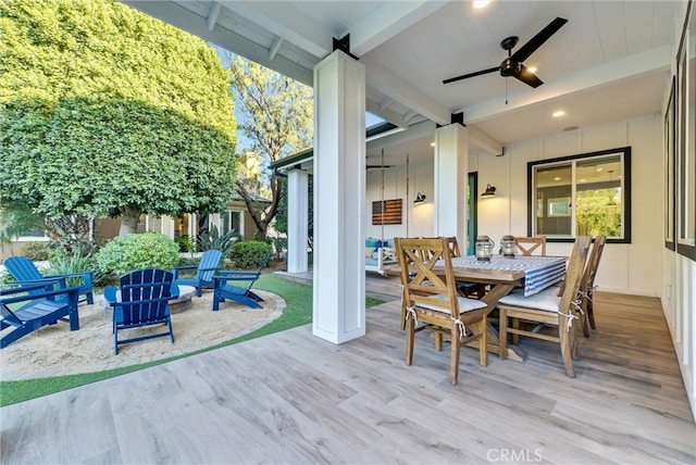 view of patio featuring outdoor dining space, ceiling fan, and a wooden deck