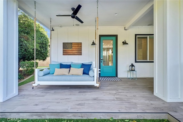 wooden terrace featuring a ceiling fan and outdoor lounge area