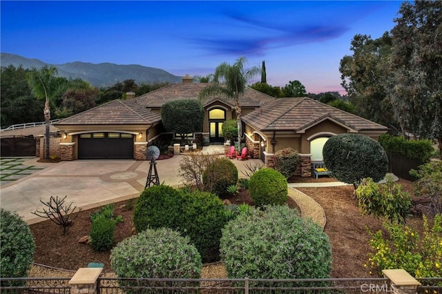 view of front of home featuring a garage, concrete driveway, a chimney, a tiled roof, and fence