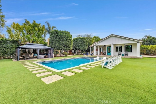 view of pool featuring a patio, a fenced in pool, a lawn, and a gazebo