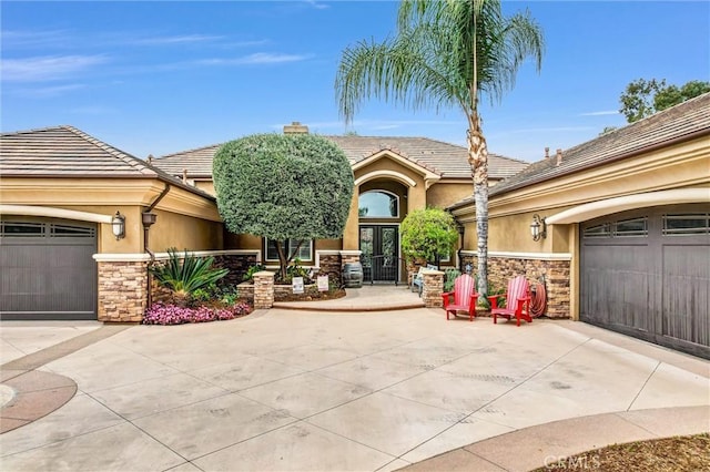 2480 Oak Ave, Corona, CA 92882 - view of front of property featuring stone siding, stucco siding, concrete driveway, and a chimney