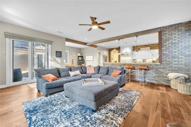 2480 Oak Ave, Corona, CA 92882 - living area with ceiling fan, light wood-style flooring, and brick wall