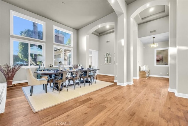 2480 Oak Ave, Corona, CA 92882 - dining room featuring a high ceiling, wood finished floors, arched walkways, and baseboards