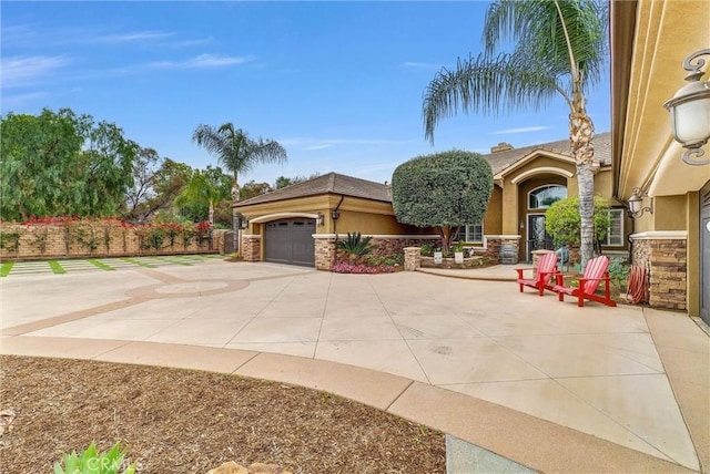 2480 Oak Ave, Corona, CA 92882 - view of front of property with stucco siding, driveway, an attached garage, fence, and stone siding