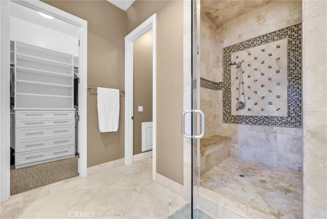 2480 Oak Ave, Corona, CA 92882 - bathroom featuring a stall shower, a walk in closet, and baseboards