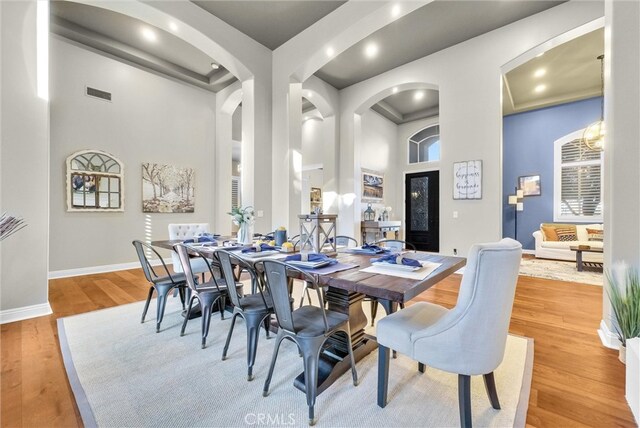 2480 Oak Ave, Corona, CA 92882 - dining room with a towering ceiling, arched walkways, light wood finished floors, baseboards, and recessed lighting