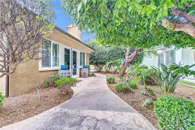 2480 Oak Ave, Corona, CA 92882 - view of exterior entry with a chimney and stucco siding