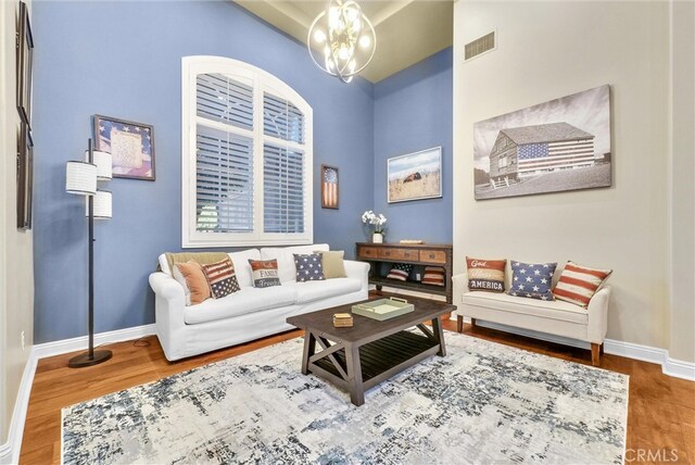2480 Oak Ave, Corona, CA 92882 - living room with a chandelier, wood finished floors, and baseboards