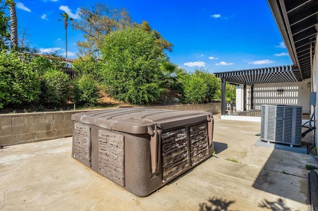 view of patio featuring central air condition unit, a pergola, and a hot tub