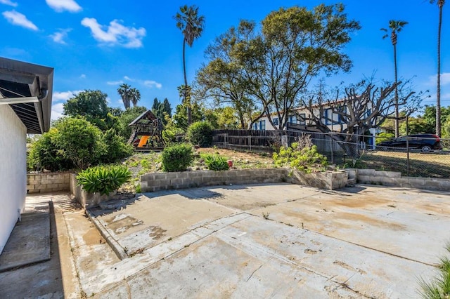 view of patio / terrace featuring a fenced backyard and a playground