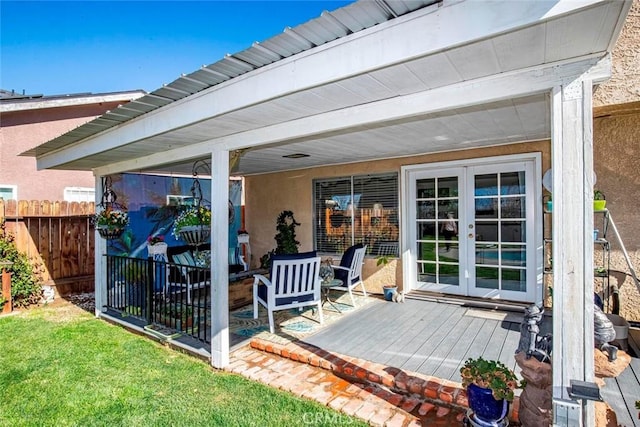 view of patio featuring fence, a deck, and french doors