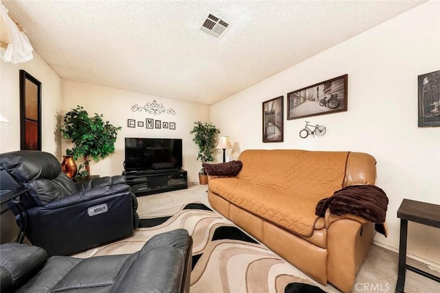 carpeted living room featuring visible vents and a textured ceiling