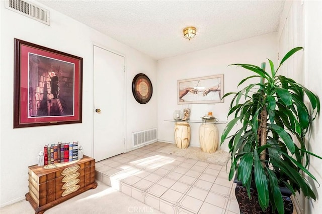 entryway featuring visible vents and a textured ceiling