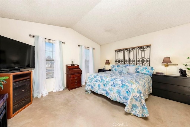 bedroom featuring lofted ceiling, carpet flooring, and a textured ceiling