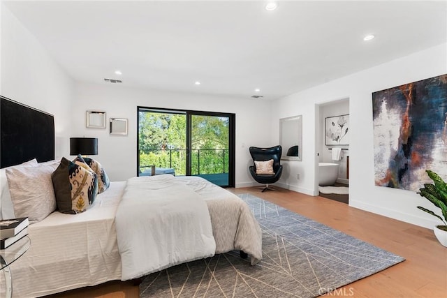 bedroom featuring baseboards, visible vents, wood finished floors, ensuite bathroom, and recessed lighting