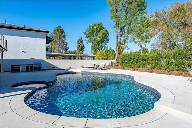 view of swimming pool featuring fence, a fenced in pool, and a patio