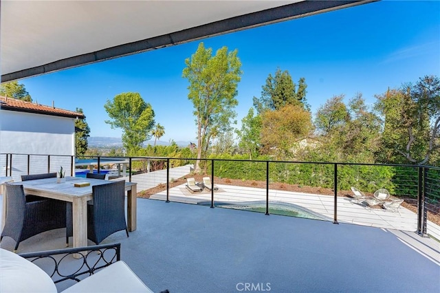 balcony with outdoor dining space and a patio area