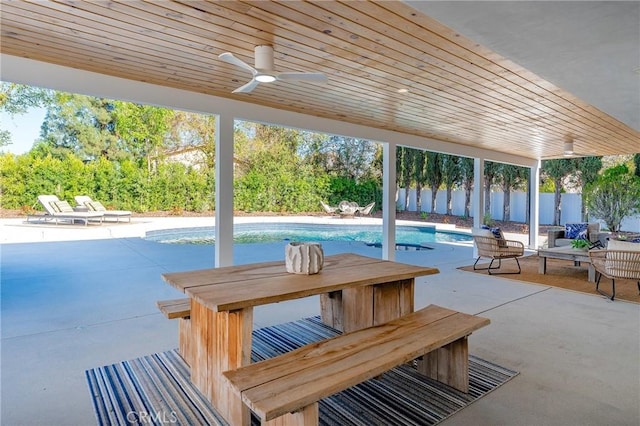 view of patio / terrace with a fenced in pool, fence, and a ceiling fan