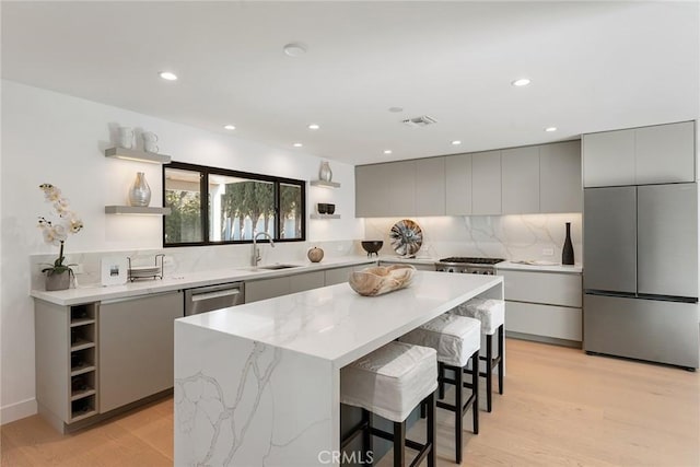 kitchen featuring open shelves, modern cabinets, gray cabinets, and stainless steel appliances