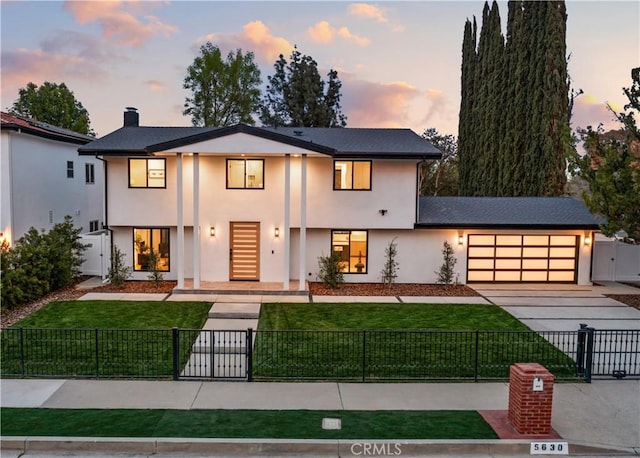 view of front of home featuring a lawn, a fenced front yard, and stucco siding